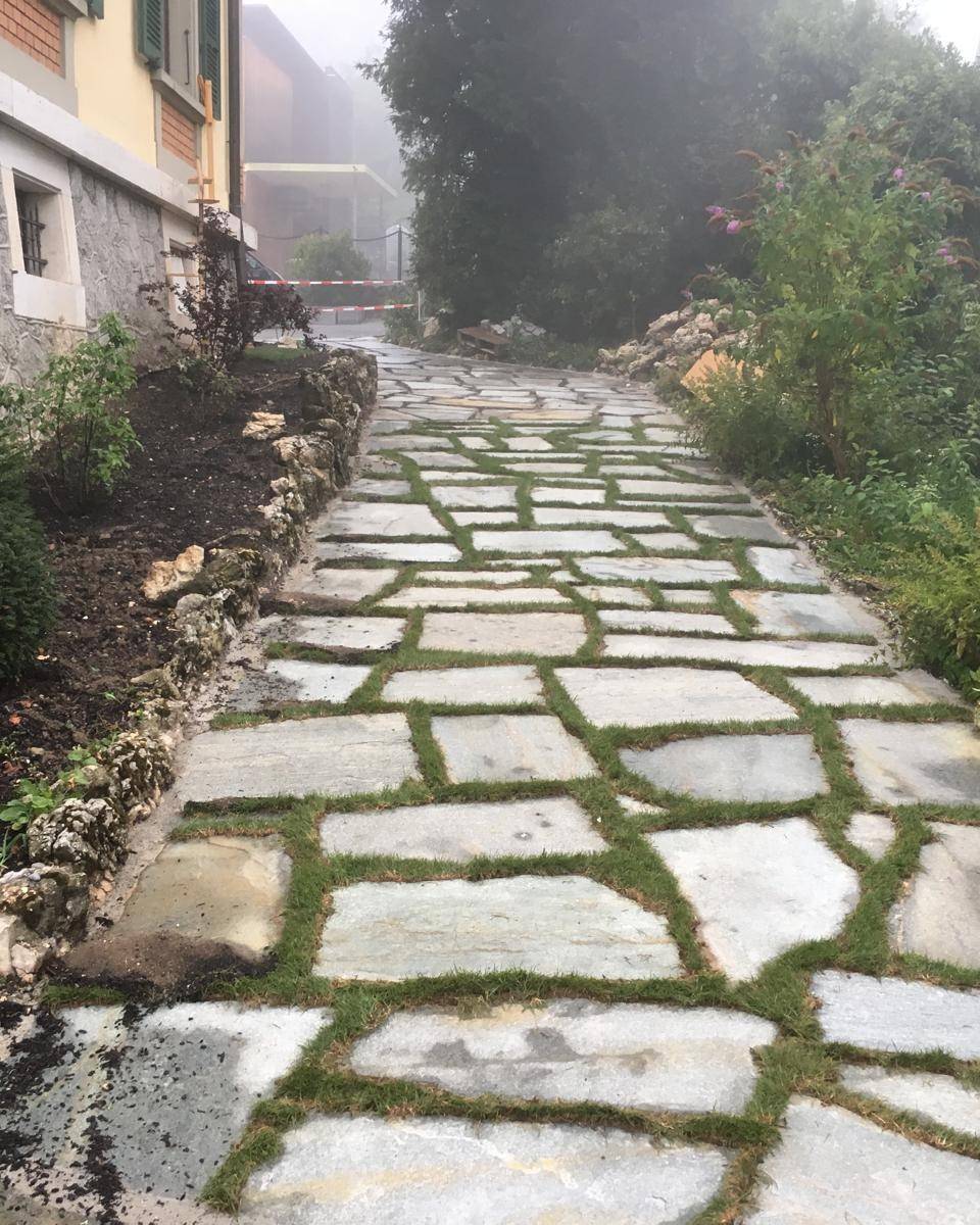 Terrasse en dalles de marbre blanc en bordure de jardin